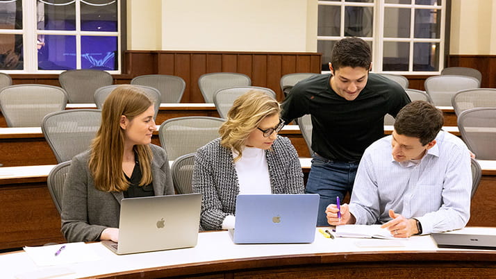 A group of students works together in a Kellogg classroom